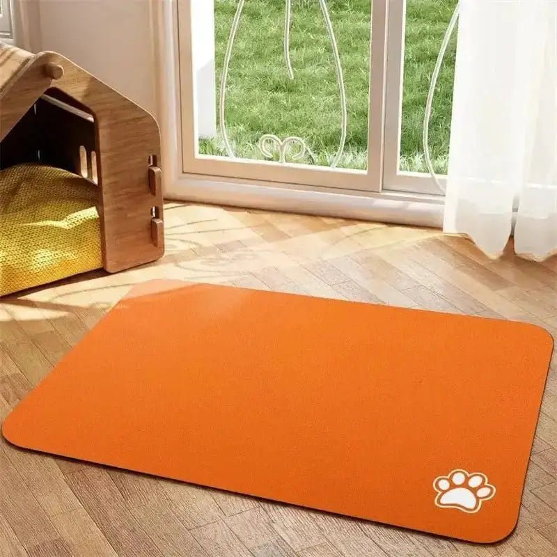Tapis de protection sous gamelle pour chien antidérapant en orange avec empreinte de patte