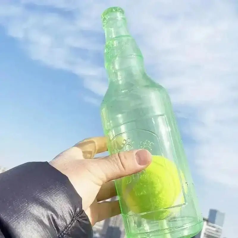 Image d’une bouteille en verre verte avec balle de tennis, jouet interactif pour chien